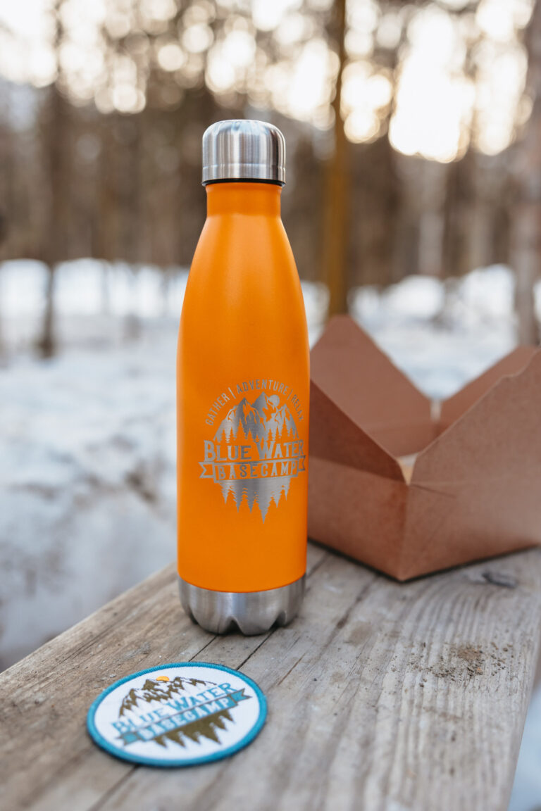 Orange branded water bottle on bench.